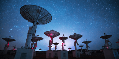 Radioteleskop riktade mot stjärnhimlen under natten, används för att upptäcka radiosignaler från rymden.
